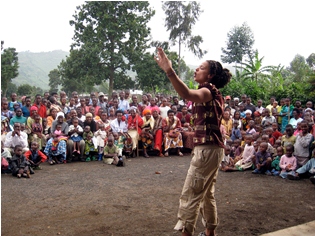 UF Theatre student performing a spoken word piece in a genocide survivor village in Rwanda.
