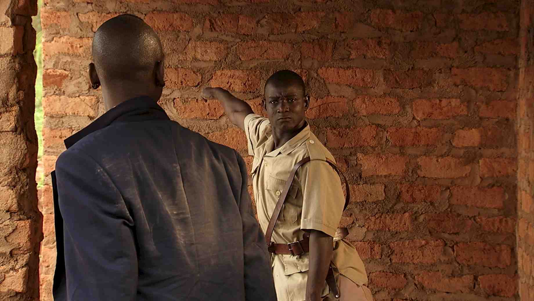 Souleymane Badolo, in NORA, as the policeman who attempts, but fails, to remove young Nora and her brother from their home.