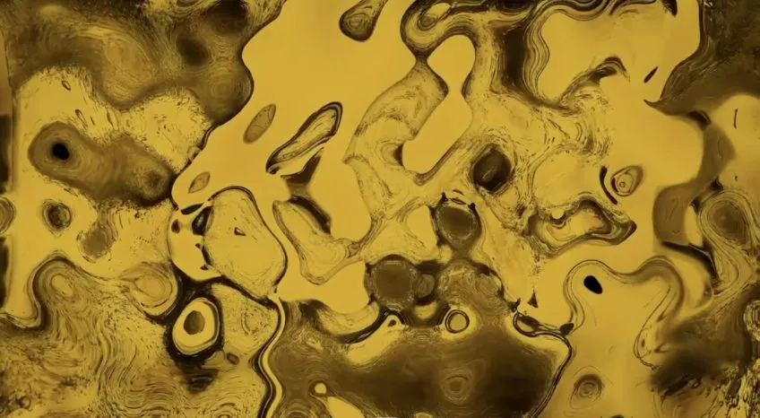Video still. Abstract art with golden-yellow swirl pattern.