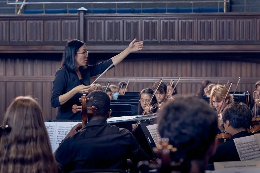 Tiffany Lu conducts a student orchestra ensemble