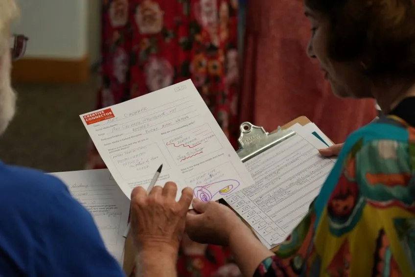 A person holding a clipboard and paper with 