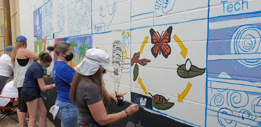 COTA staff painting a mural