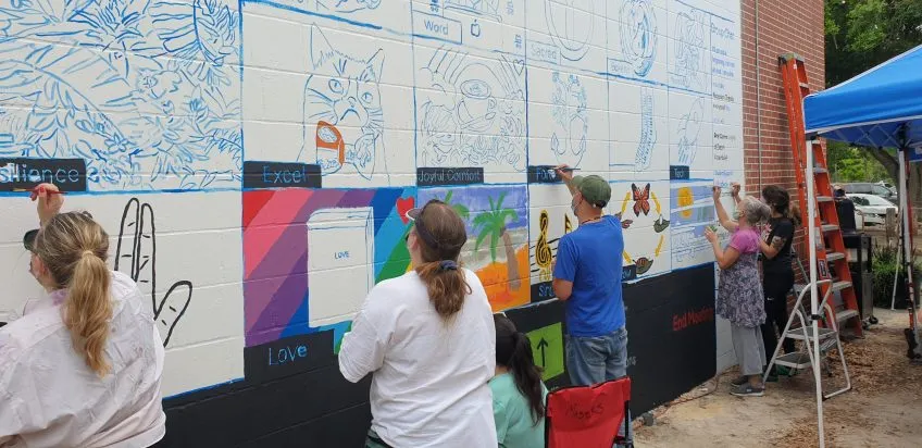 COTA staff painting a mural