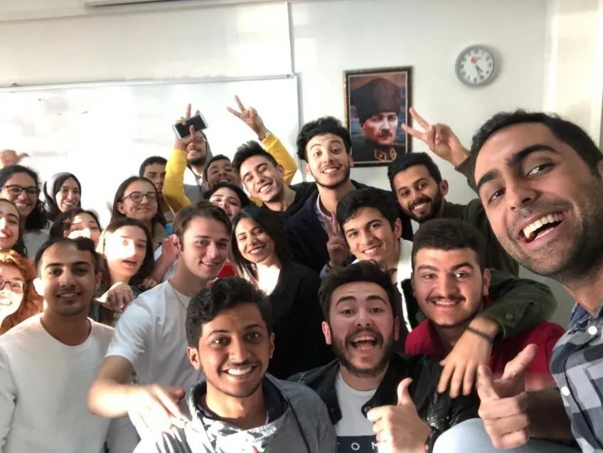 Afsheen Misaghi with students in classroom.