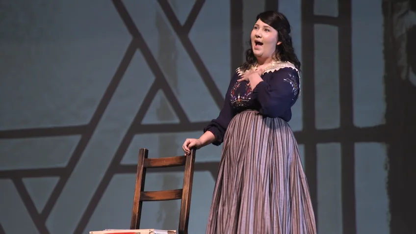 A female opera singer performs on stage