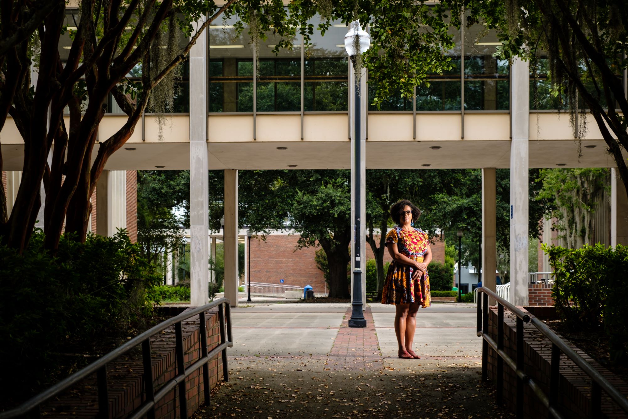 Dean Onye Ozuzu stands in front of a building on the University of Florida campus.
