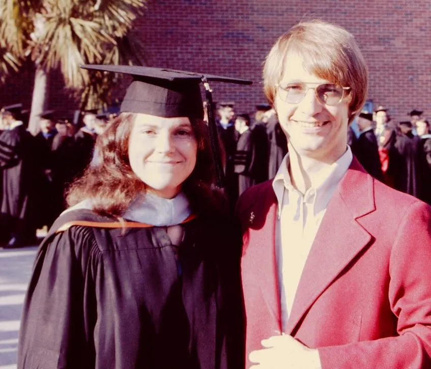 1975 photo of Anne in graduation regalia and Rolf in a maroon blazer