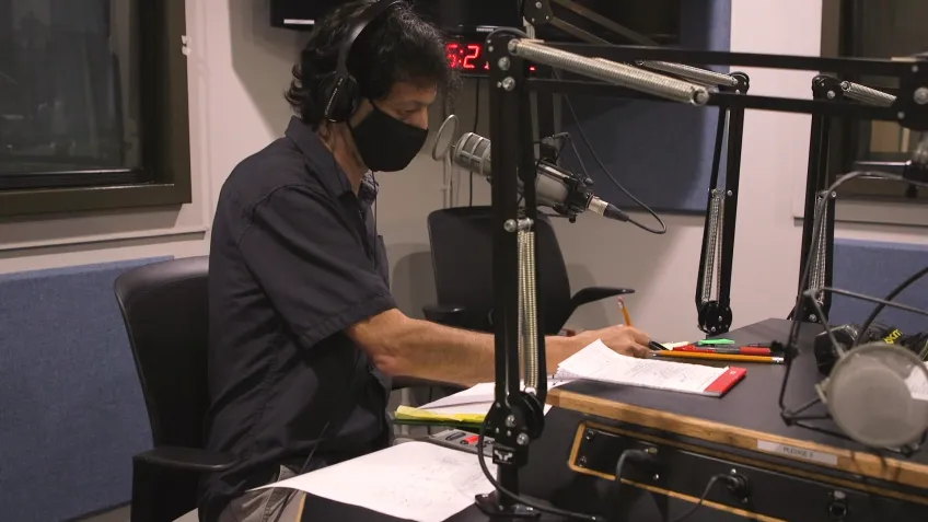 An audio engineer in a recording booth