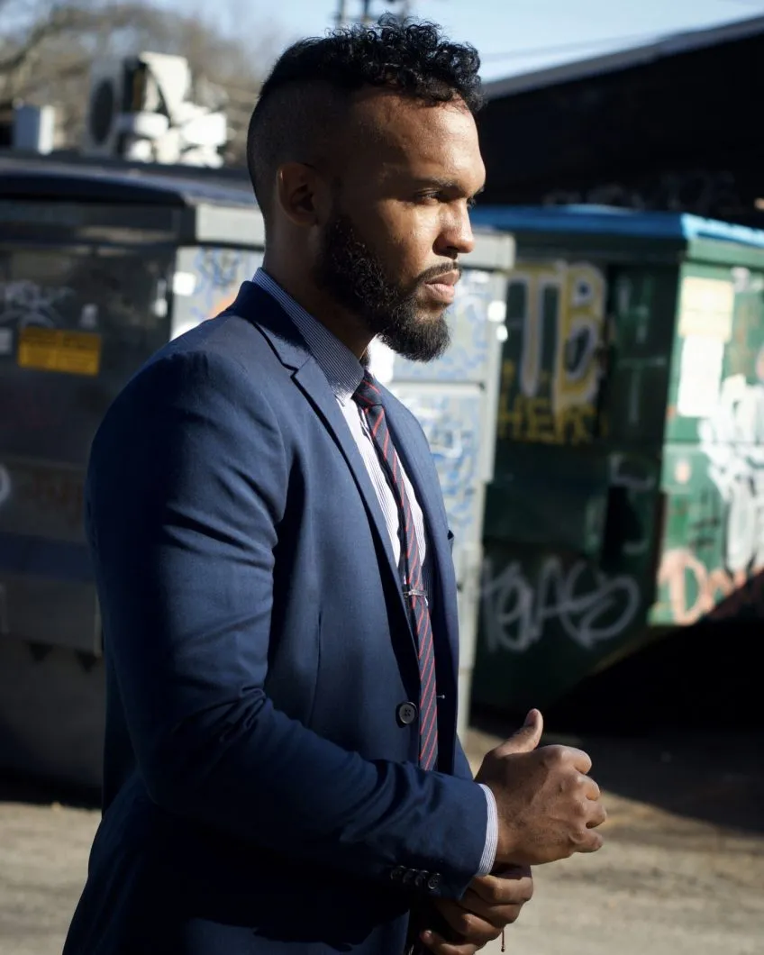 Ryan Hope Travis pictured from the waist up in right-facing profile.