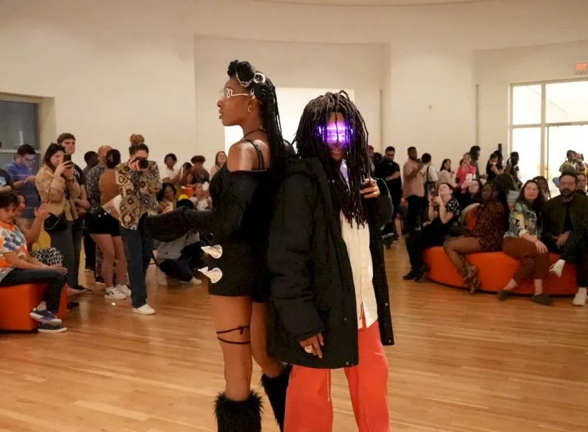 Fashion show with Black models wearing futuristic clothing and accessories
