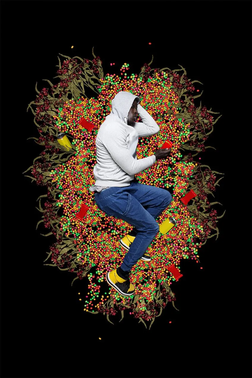 Digital photo artwork: A black man in gray hooded sweatshirt lies in fetal position on colorful 