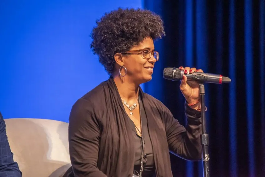 COTA dean Onye Ozuzu speaks into a microphone at Creating Healthy Communities