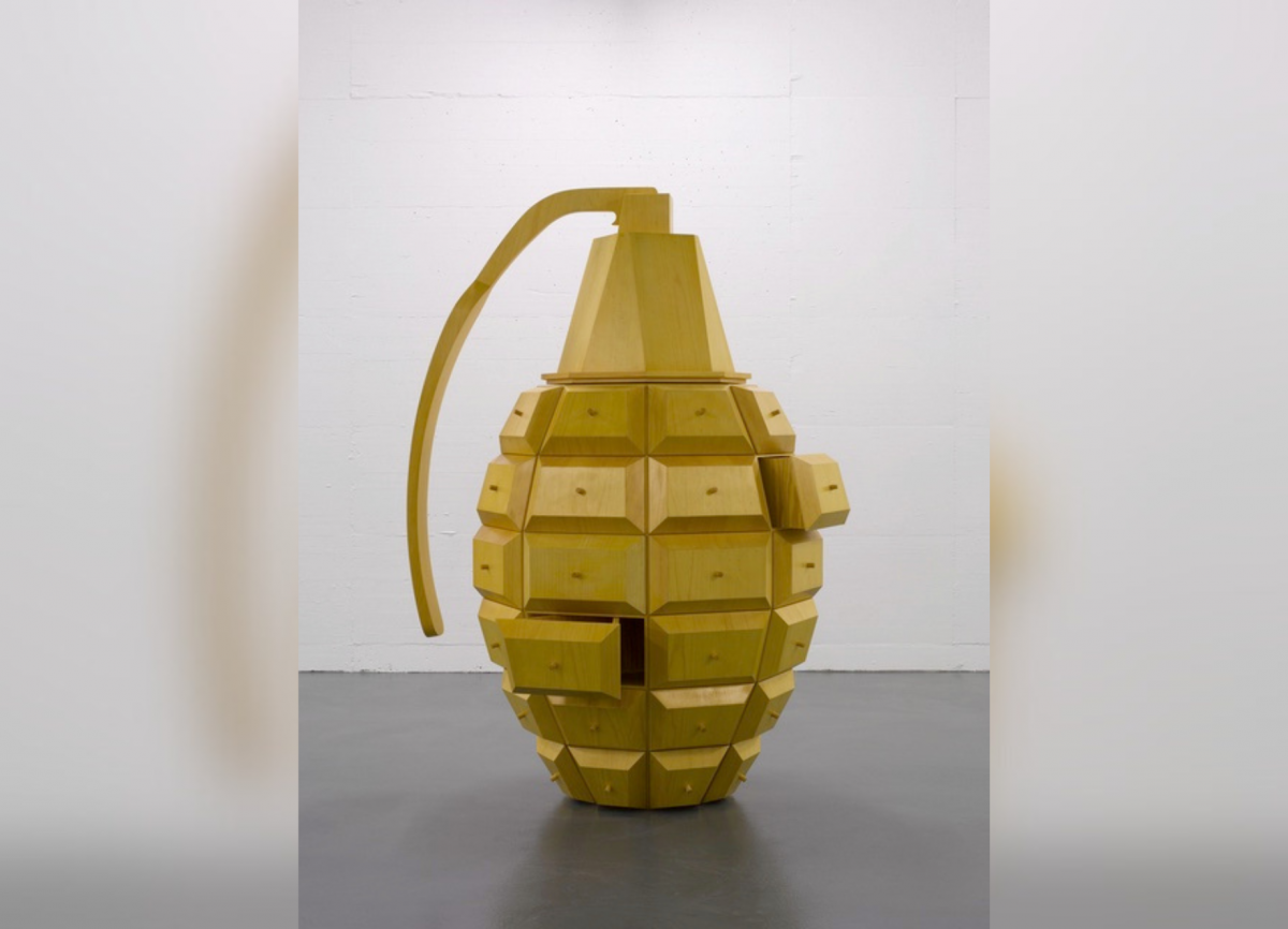 Wooden sculpture of a hand grenade with drawers that pull out