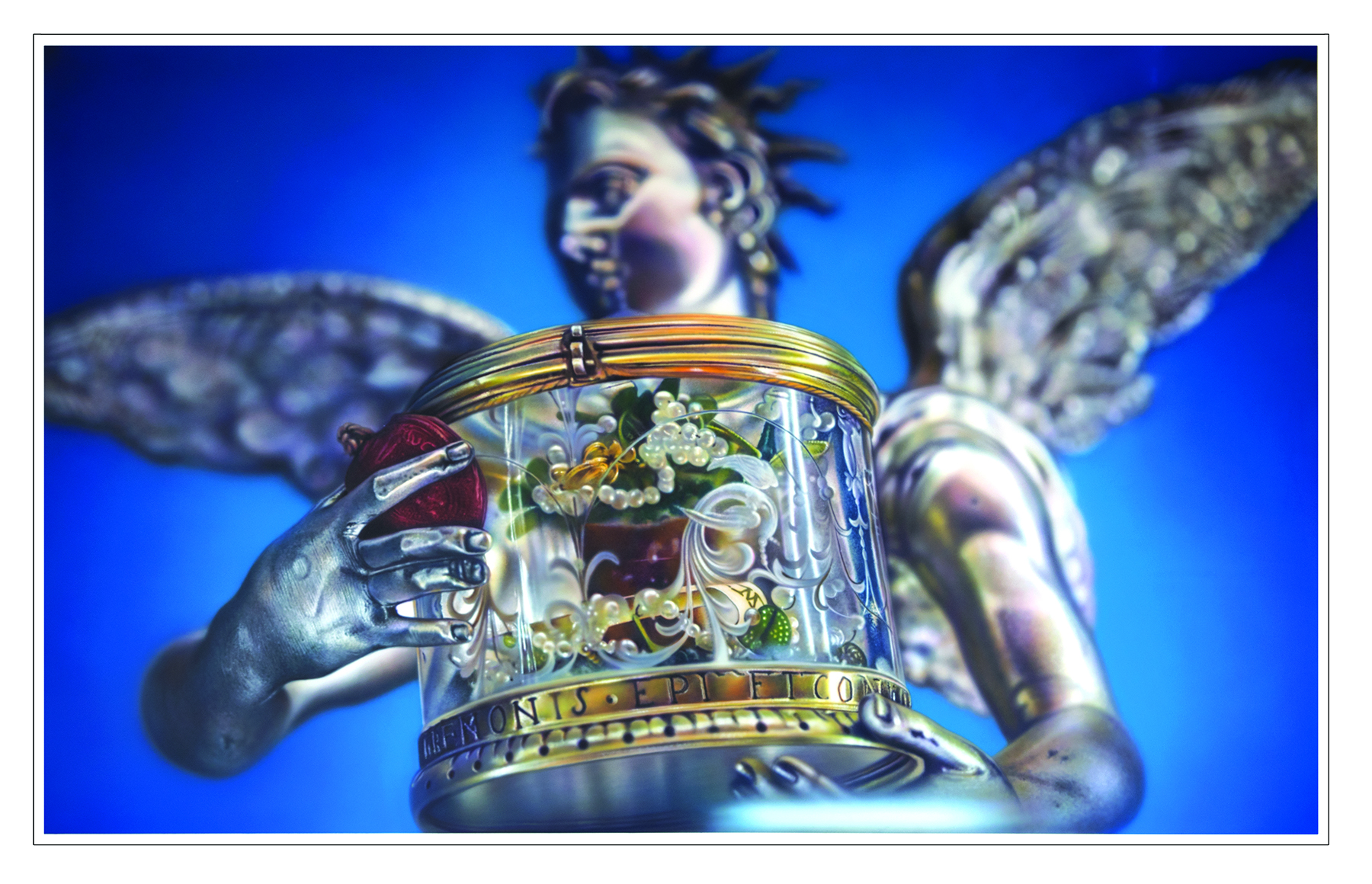 Image description: a silver plastic angel, Baroque sculptural style, holding a glass container with assorted trinkets and pearls