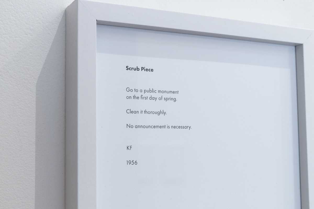 Framed paper with text that reads: "'Scrub Piece.' Go to a public monument on the first day of spring. Clean it thoroughly. No announcement is necessary. KF. 1956"