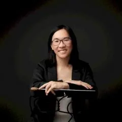 Headshot photo of Tiffany Lu with a conductor