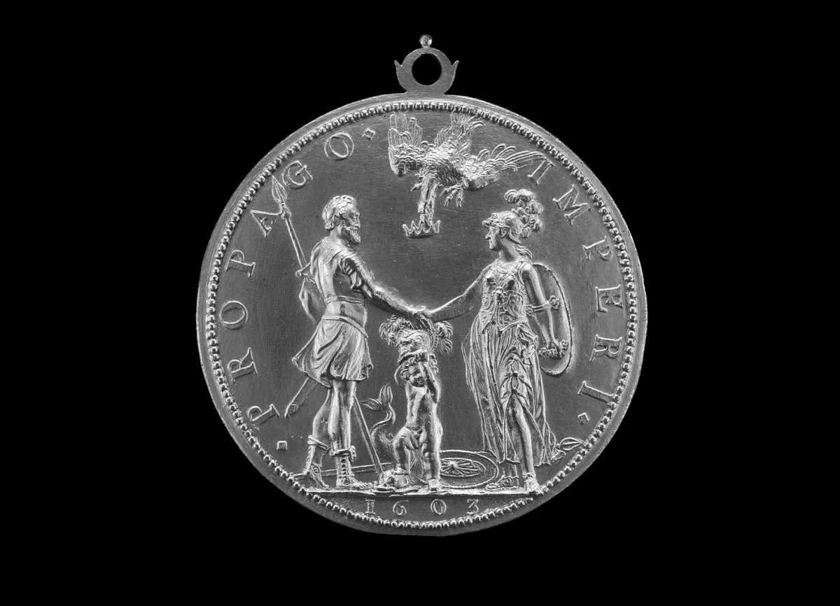 A silver coin with Roman or Greek Gods Mars and Athena shaking hands