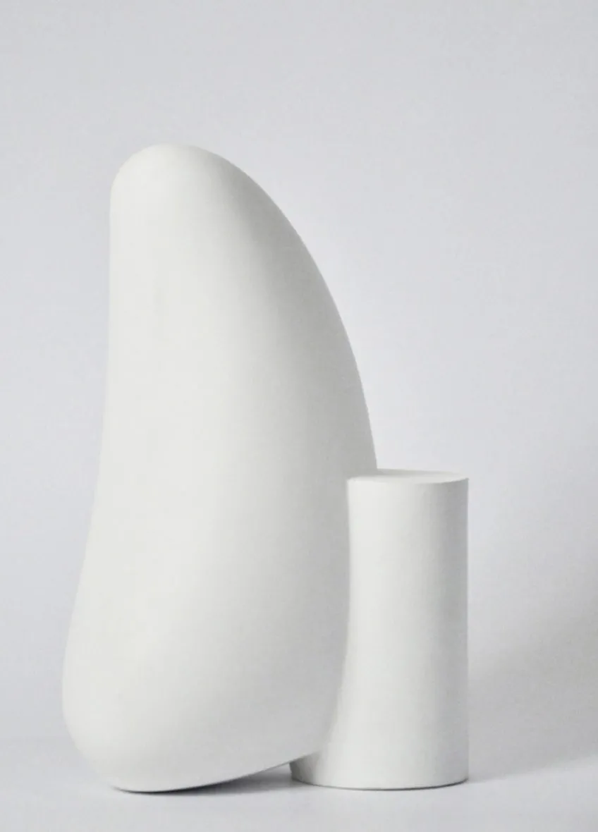 Image description: Minimalist matte white sculpture against white background