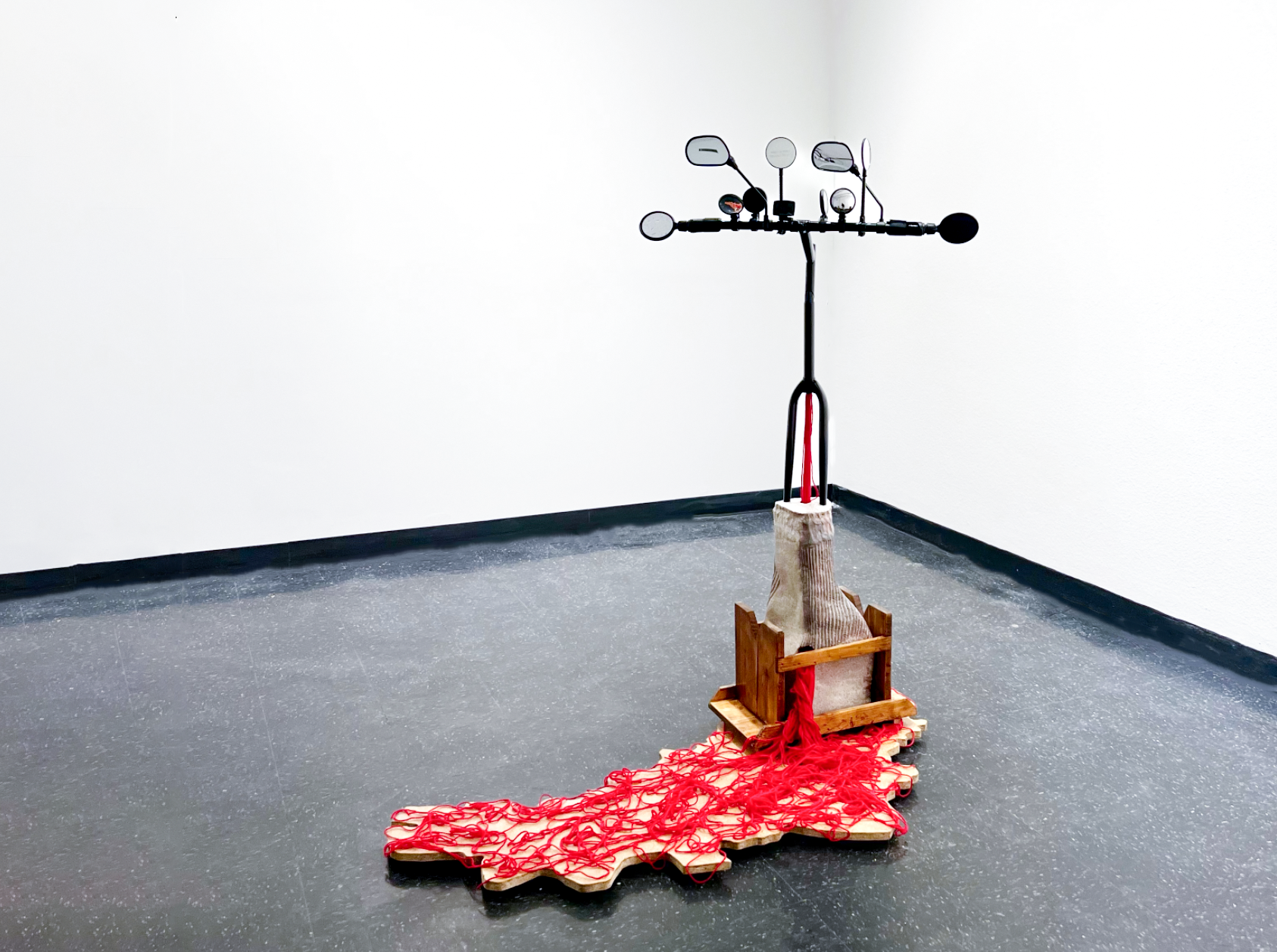 Eugene Ofori Agyei sculpture titled: "In the World through which I travel, I am endlessly creating myself” Franz Fanon, 2023. Mixed media: Earthenware clay, yarn, wooden stool, found object.