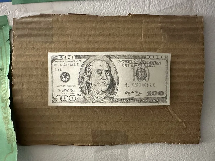 A pencil-drawn replica of a U.S. 100-dollar bill.