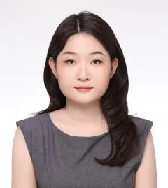 Image of Yae-na. Yae-na has medium length dark hair and is wearing a grey dress.