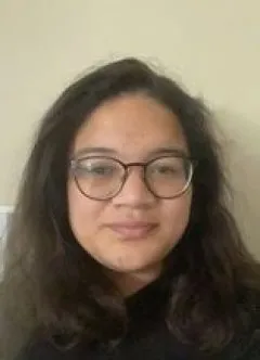 Selfie of Illiana wearing glasses and a dark shirt. Illiana has medium length brown hair