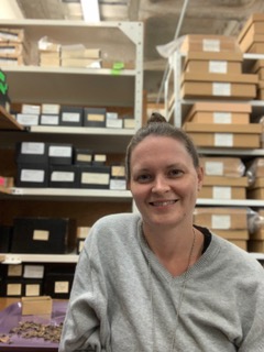 Image of Jessica. Jessica has brown hair pulled into a bun and is wearing a grey sweater.