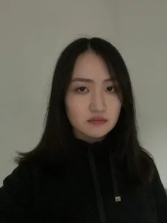 Image of Qian. Qian has medium length black hair and is wearing a black jacket