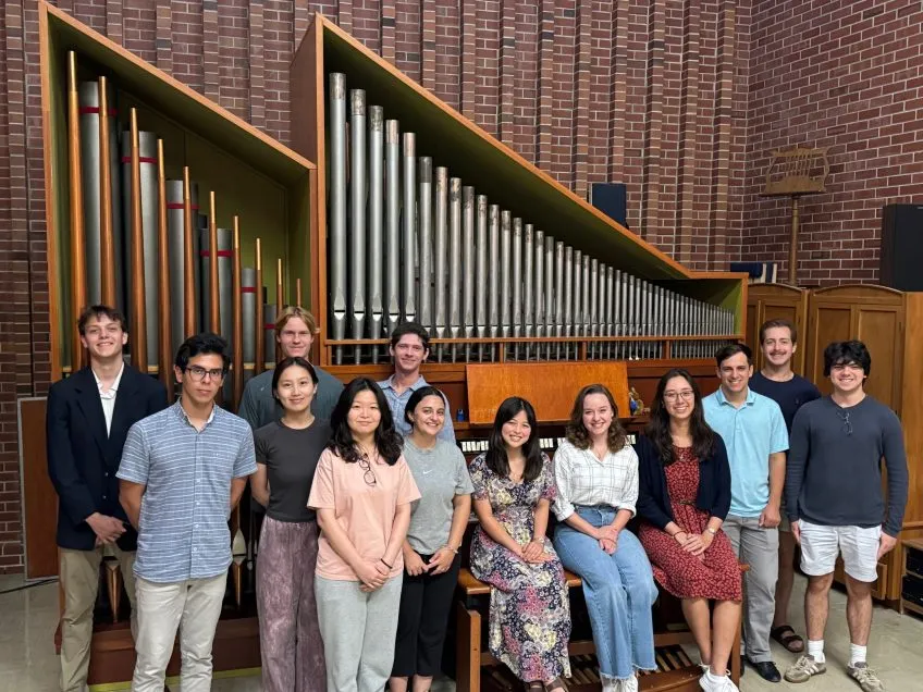 Organ Studio group standing in front of organ.