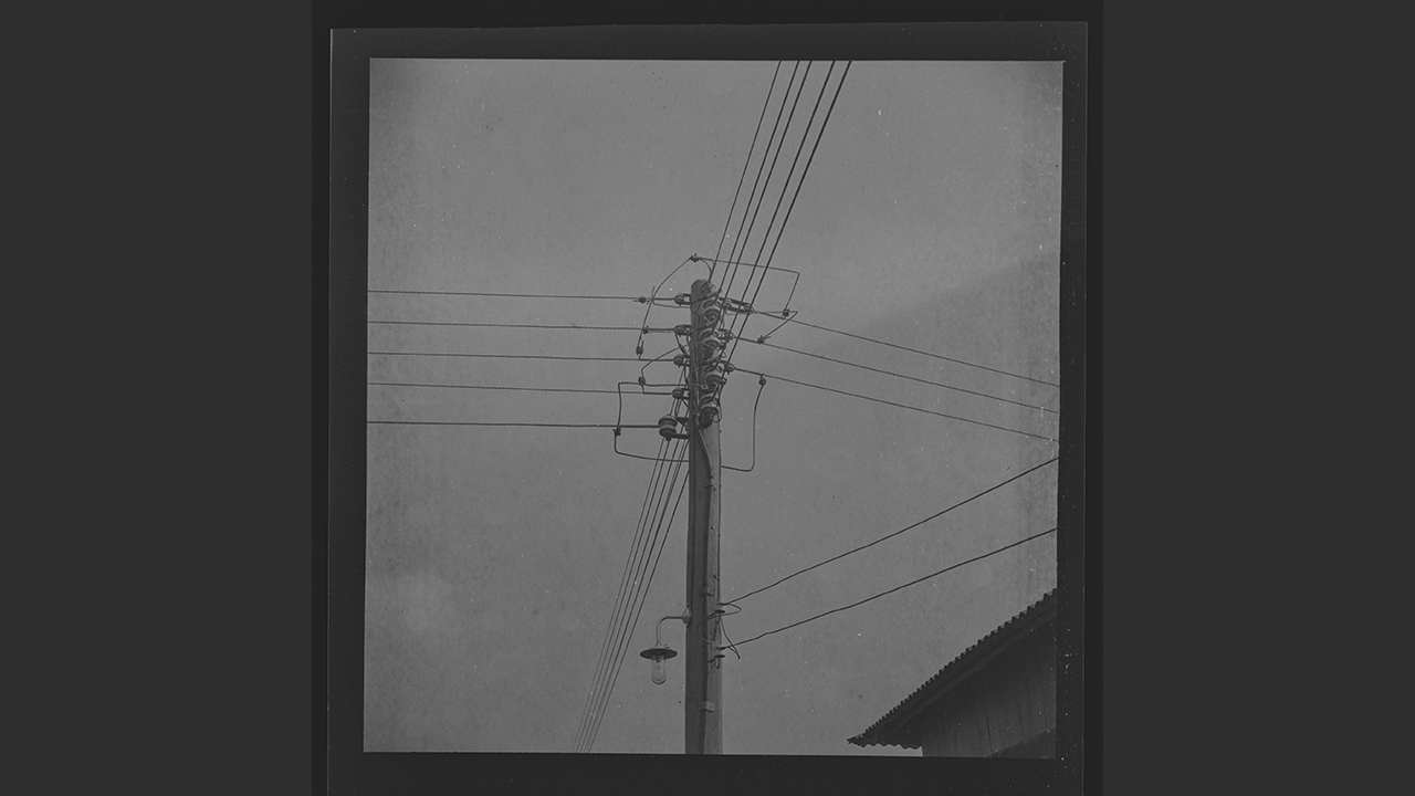E.H. Duckworth, Film negative of electrical transmisson lines attached to a pole, at Aiyetoro, mid-20th century.