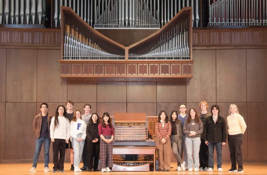 Group of Organ Studio students standing next to organ.
