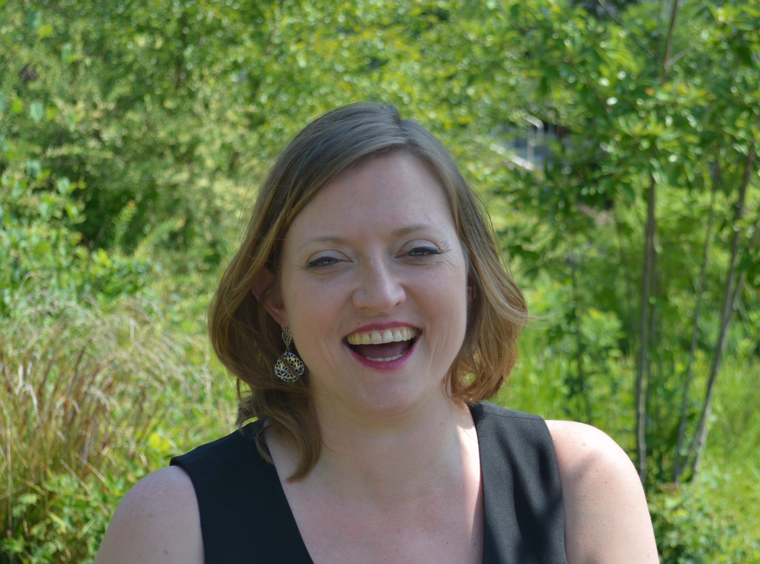 Photo of Jill Rogers. Jill has short brown hair and a black sleeveless top on.