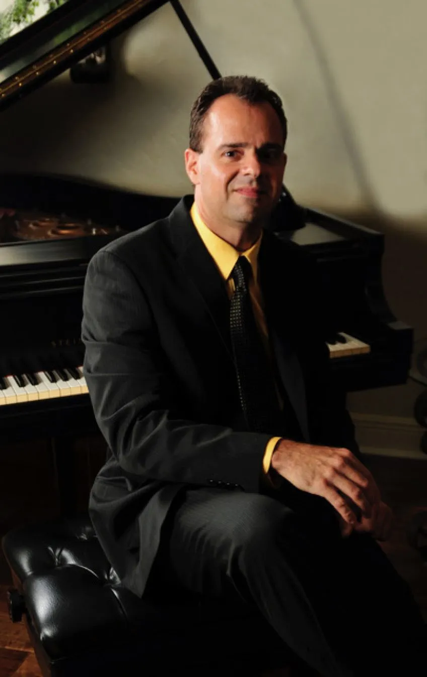 Kevin Orr seated at a piano.