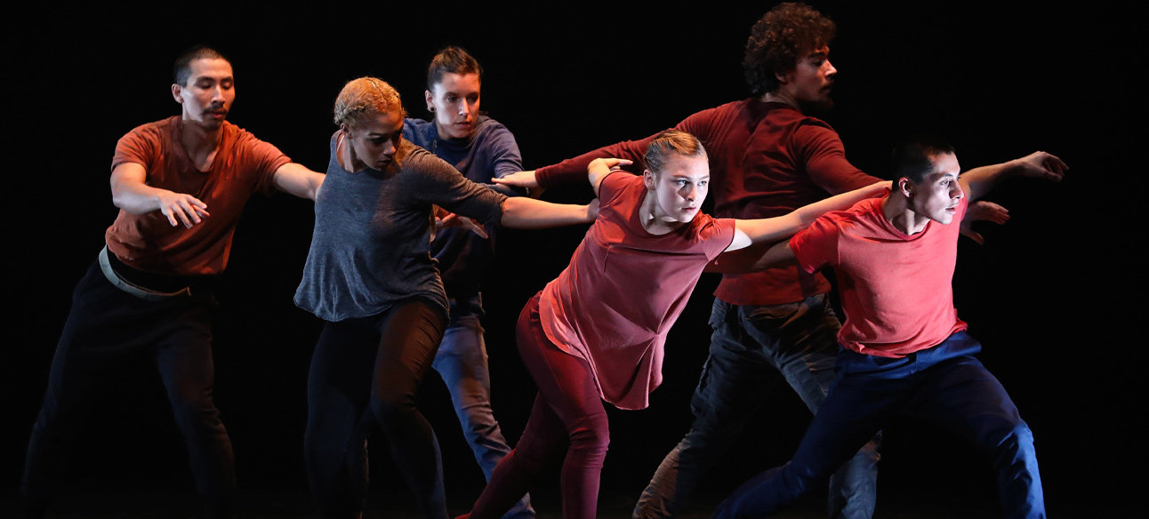 Image of 6 dancers on stage mid-performance.
