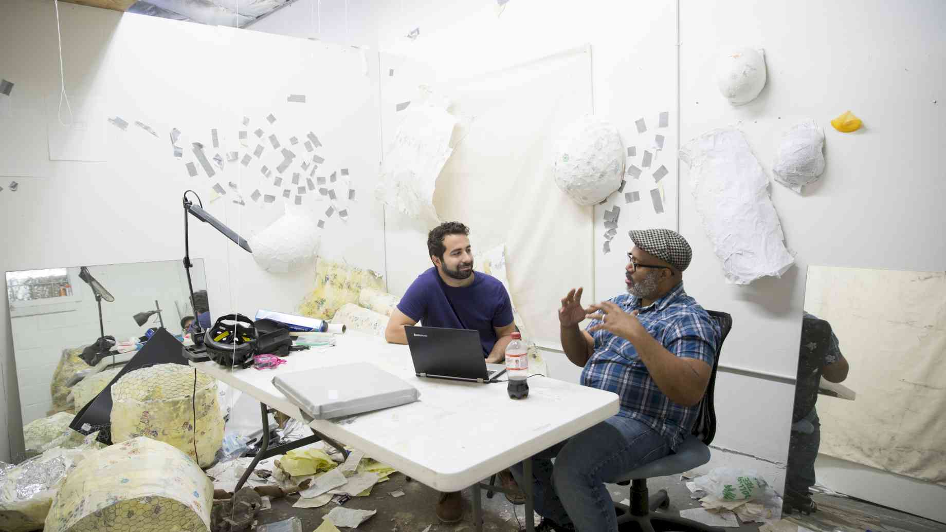 Visiting Artist Trent Doyle Hancock (right) conducts a studio visit with Art + Tech grad student Chris Bianchi
