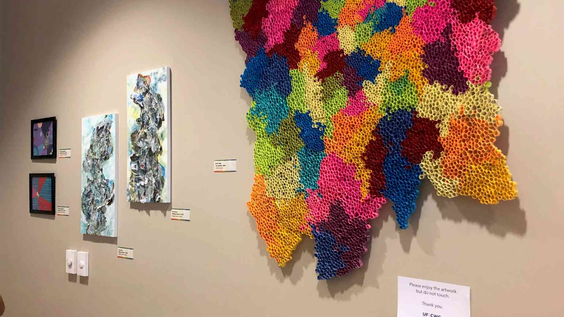 Artwork by studio art students displayed in the UF Counseling and Wellness Center