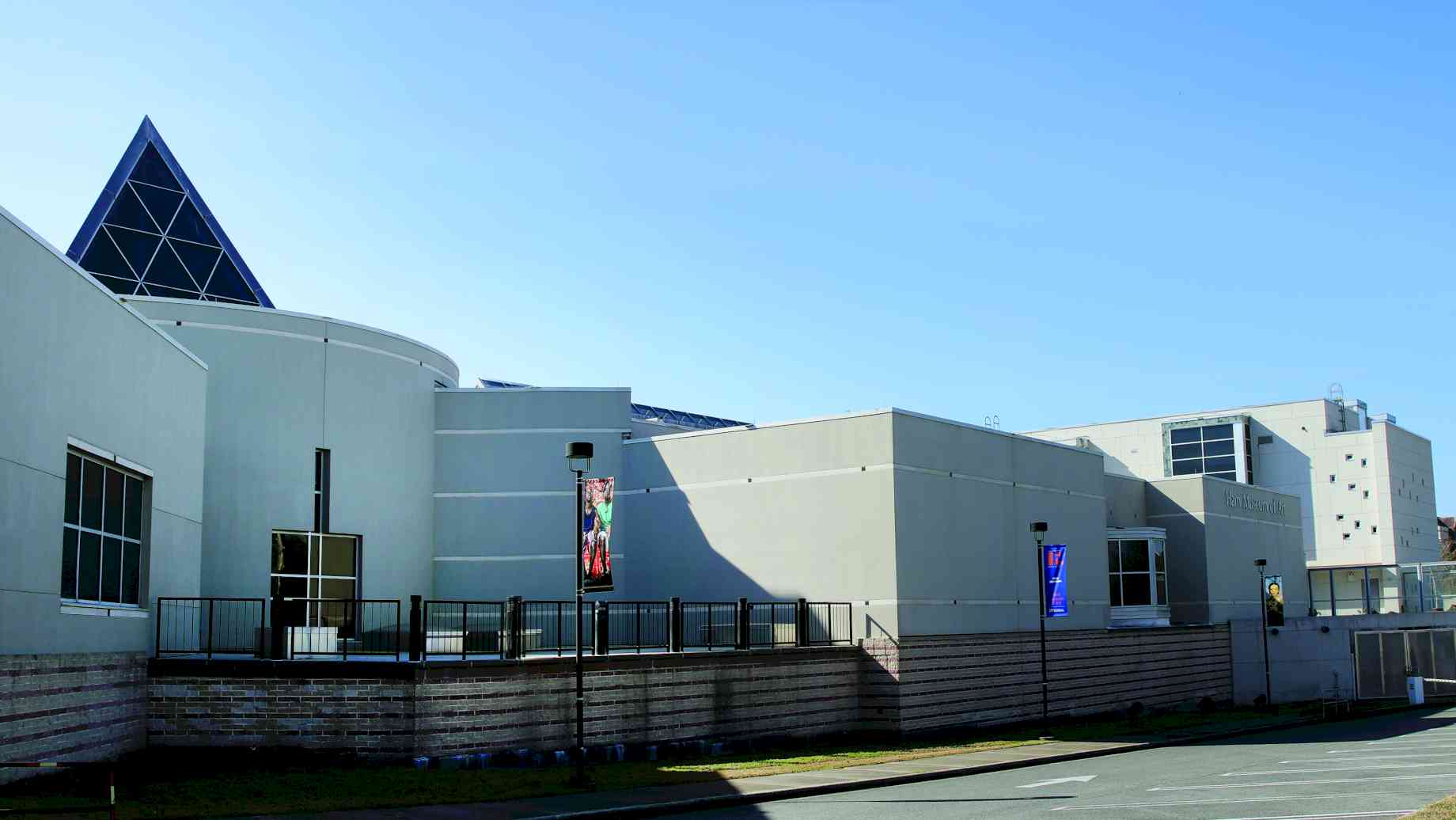 The Harn Museum of Art. Photo credit: The Harn Museum. [Alt text: The front of the museum, a geometric white building.]