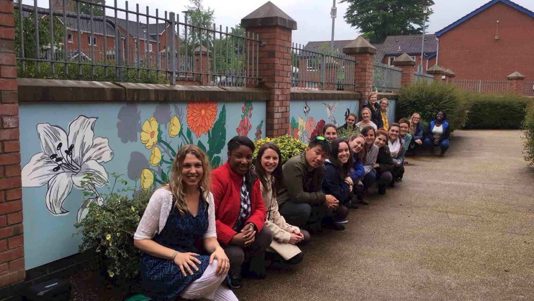 Study abroad students help paint a mural at a residential home for people with dementia in Northern Ireland.